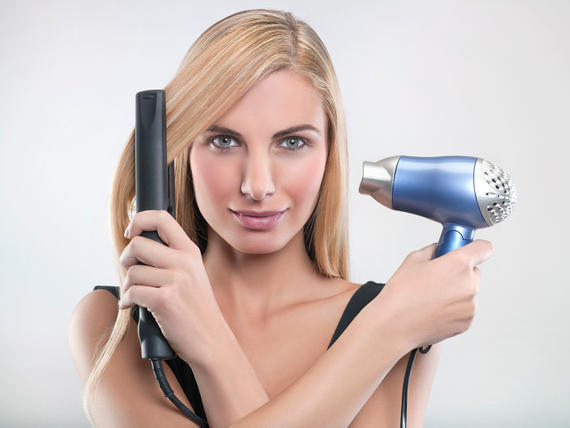 Young woman using hair straighteners and hair dryer Image downloaded by makyaj puan at 19:39 on the 30/08/13